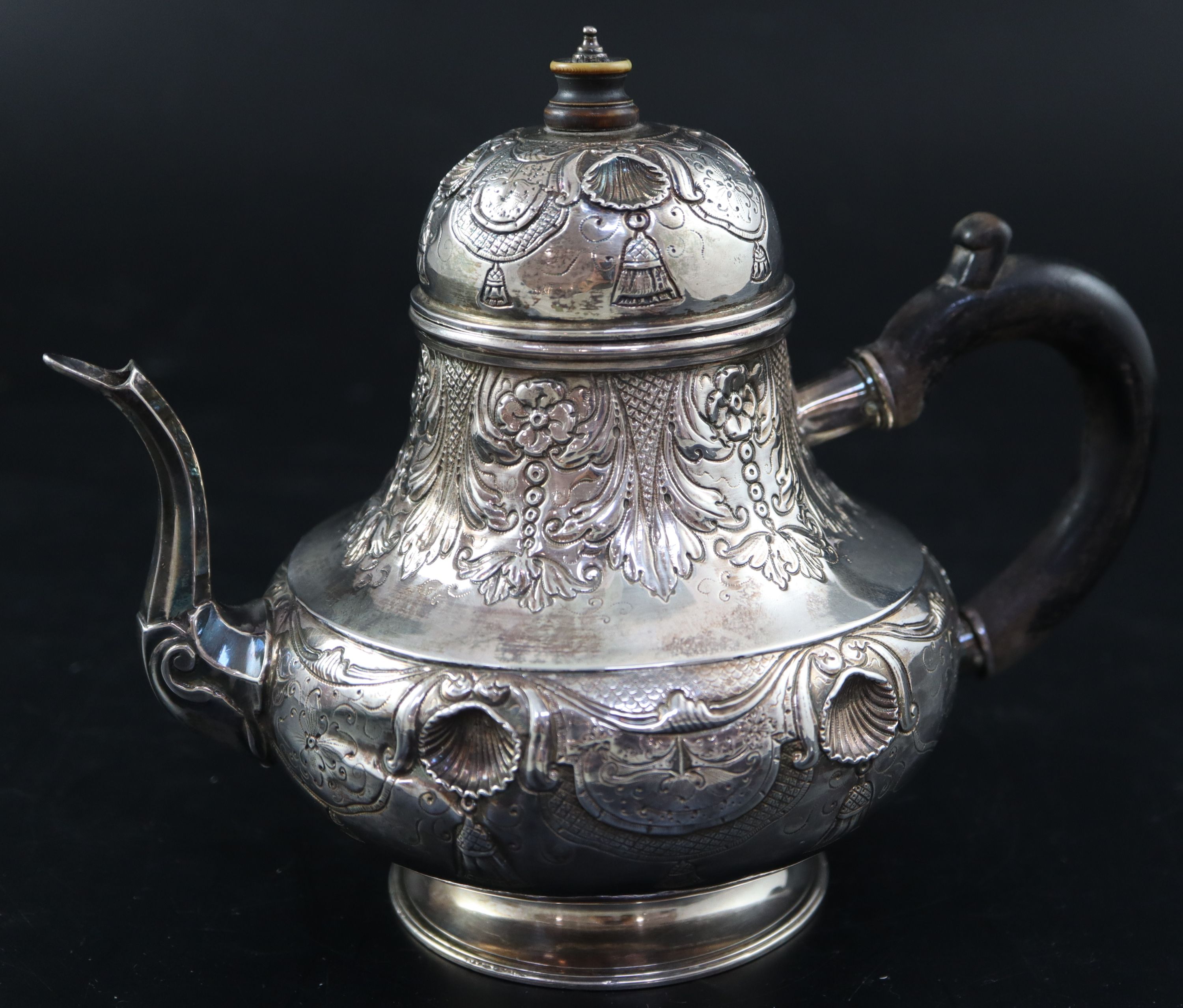 A late 18th/early 19th century Dutch embossed white metal pear shaped teapot, height 15.3cm, gross 10oz.